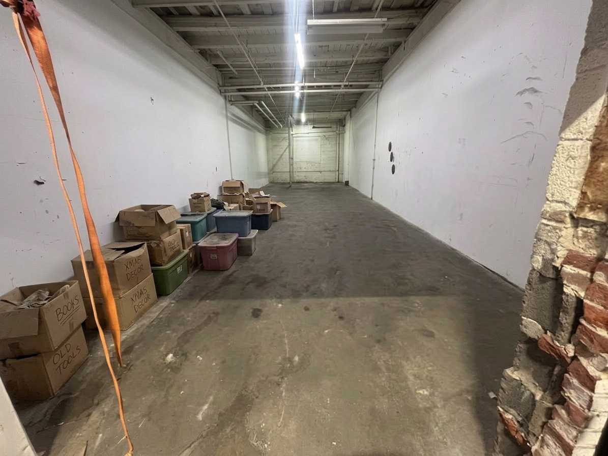 Garage filled with boxes and clutter before junk removal