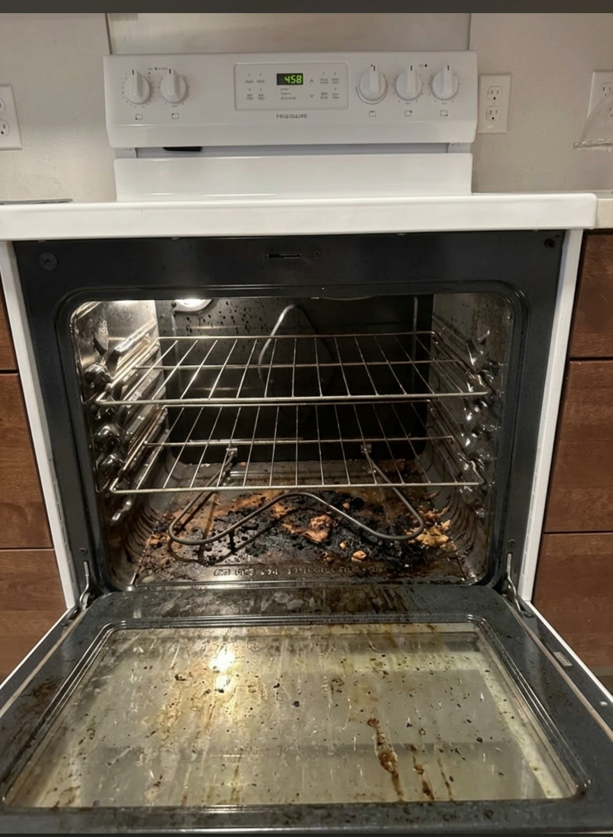 Oven with burnt-on grease and charred food residue before cleaning