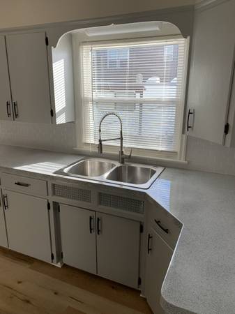 Sparkling clean white kitchen with gleaming sink