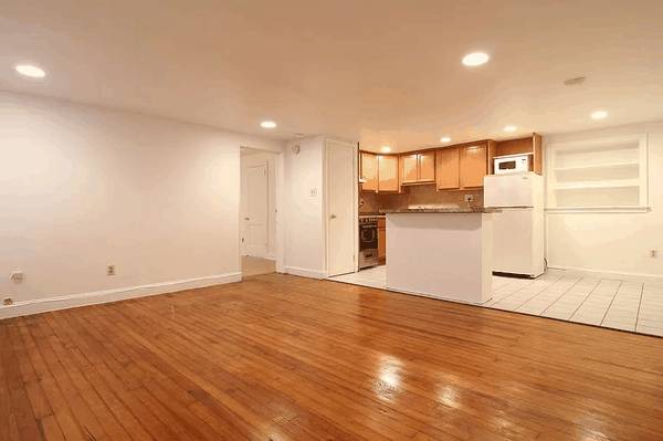 Open floor plan living area with polished floors