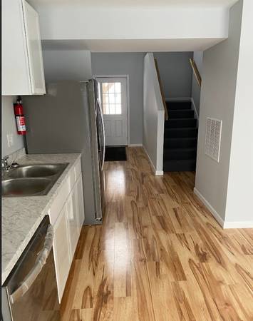 Clean hallway and kitchen with gleaming floors